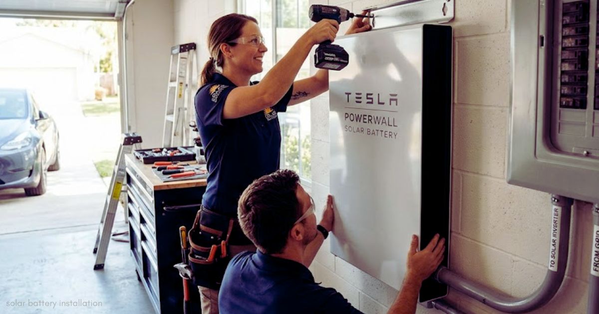 Professional solar battery installation of a wall-mounted energy storage battery for residential solar power.