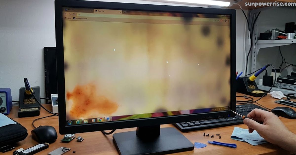 Monitor showing discoloration of screen with uneven dark and yellow patches