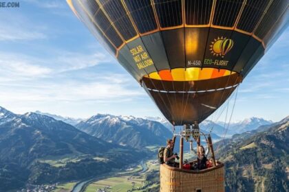 Solar hot air balloon floating in a clear blue sky powered by sunlight.