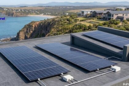 Solar panel system installed on a modern rooftop overlooking the coastline, providing clean and renewable energy.