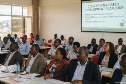 County integrated development plan presented at a community planning meeting with attendees reviewing documents and maps.