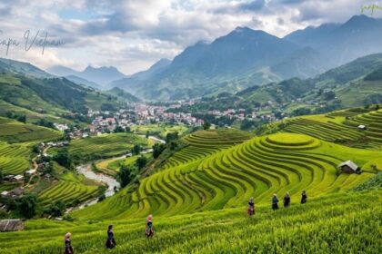 Sapa Vietnam with lush green terraced rice fields, local villagers, a winding river, mountain valley, and dramatic clouds in the background