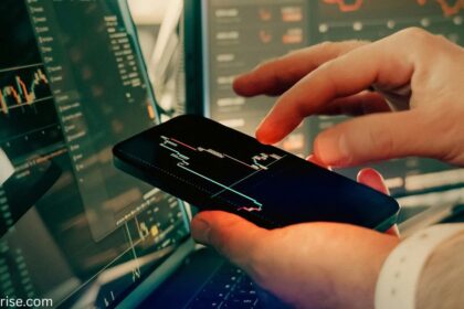 Person using a smartphone to view financial charts, illustrating what is trade credit.