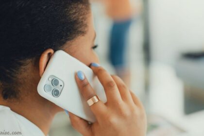 Woman holding an iPhone during a call, illustrating iPhone speaker not working on calls.