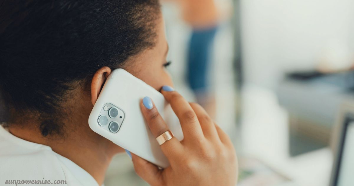 Woman holding an iPhone during a call, illustrating iPhone speaker not working on calls.