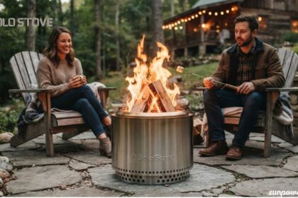Couple enjoying a campfire in a Solo Stove fire pit outside a rustic cabin in the woods.